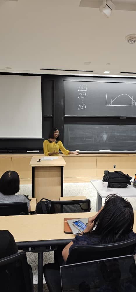 Tolulope teaching students in an in-person classroom